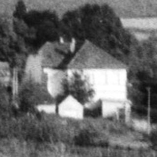 Rural village scene with church and winding road.