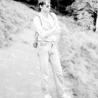 Person standing outdoors on rocky terrain.