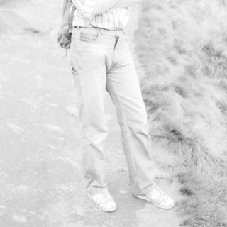 Person standing outdoors on rocky terrain.