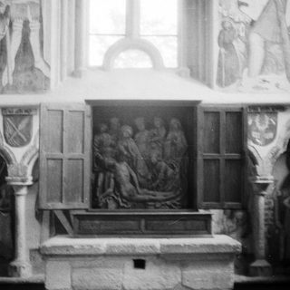Relief sculpture of crucifixion and burial scene in chapel.