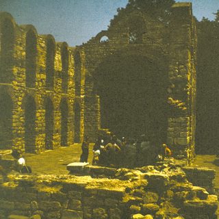 Ancient stone ruins with weathered columns and arches.