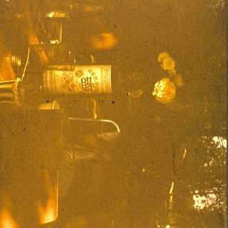 Blurry can of beer on table.