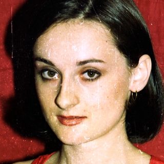 Young woman in red gymnastics leotard.