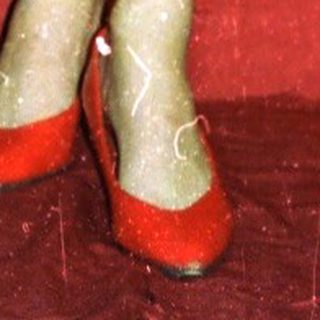 Mannequin in vintage red-and-black swimsuit with red shoes.