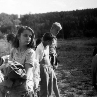 Children playing outdoors in a rural field.