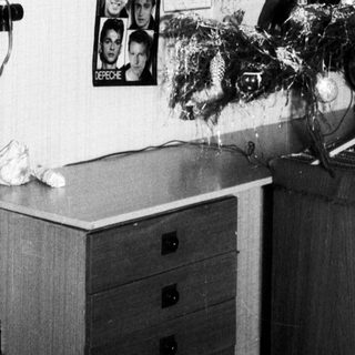 Decorated Christmas tree in vintage-style room.