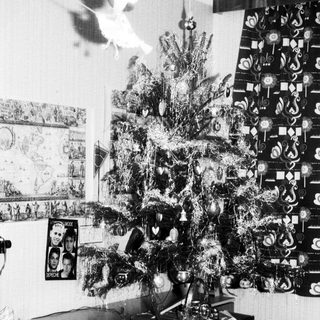 Decorated Christmas tree in vintage-style room.
