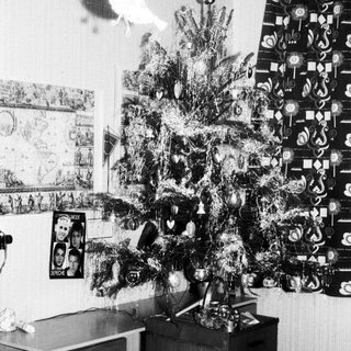 Decorated Christmas tree in vintage-style room.
