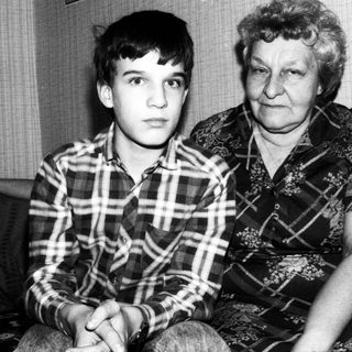 Two individuals, likely grandmother and grandson, posing together.