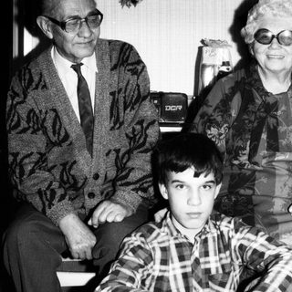 Family portrait with elderly couple and young boy.