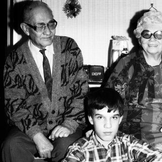 Family portrait with elderly couple and young boy.