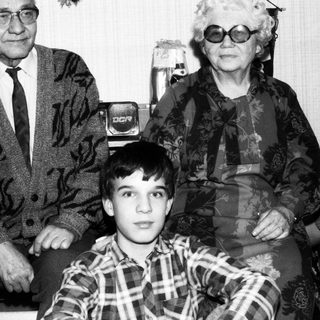 Family portrait with elderly couple and young boy.