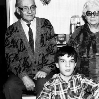 Family portrait with elderly couple and young boy.