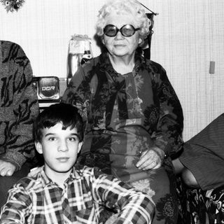 Family portrait with elderly couple and young boy.