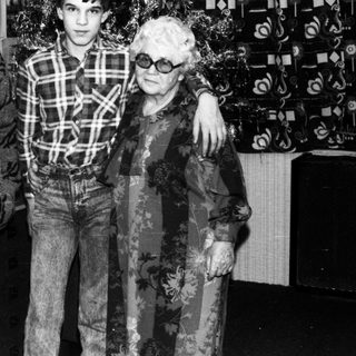 Family portrait with elderly couple and young man.