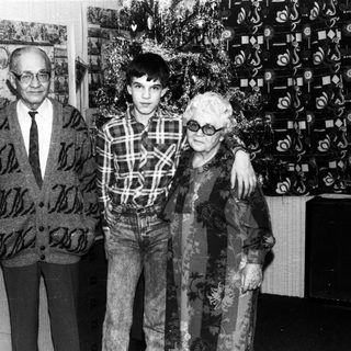 Family portrait with elderly couple and young man.