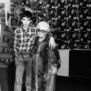Family portrait with elderly couple and young man.