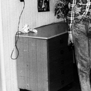 A man and woman posing together indoors, likely in the 1970s or 1980s.