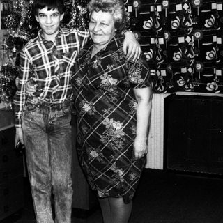 A man and woman posing together indoors, likely in the 1970s or 1980s.