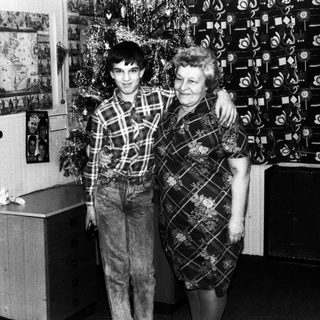 A man and woman posing together indoors, likely in the 1970s or 1980s.