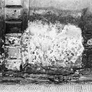 Damaged wall from explosive impact.