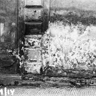 Damaged wall from explosive impact.