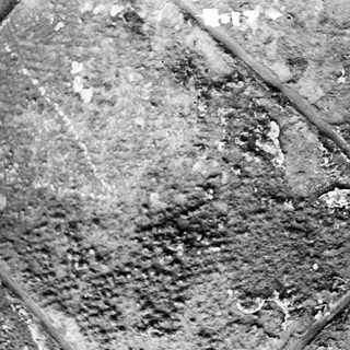 Rusted, corroded metal surface with pitted texture.