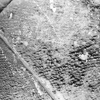 Rusted metal surface with corrosion and debris.