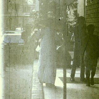 Reflection of people walking on stairs.