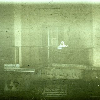 Blurred view of a person inside a small, enclosed space.