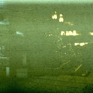 Blurry reflection of city lights through rain.
