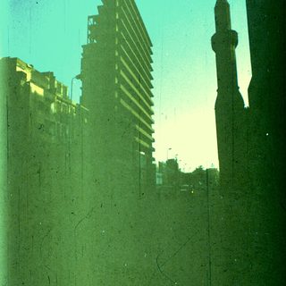 Urban skyline with modern buildings and mosque minaret.