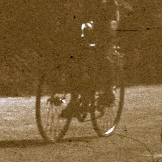 Vintage photo of people walking near bicycles.