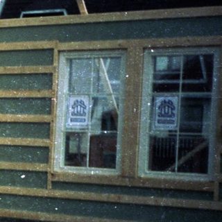 Construction site with wooden house frame under assembly.