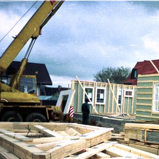 Modular house construction on elevated foundation.