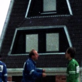 Construction workers assembling house exterior walls.