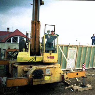 Construction workers operating heavy machinery on site.