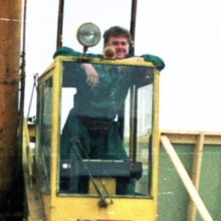 Construction workers operating heavy machinery on site.