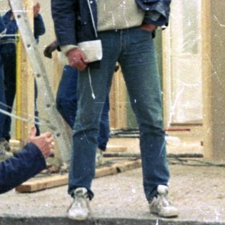 Construction workers framing a building exterior.