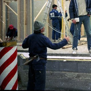 Construction workers framing a building exterior.
