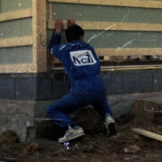 Construction workers assembling prefabricated building panels.