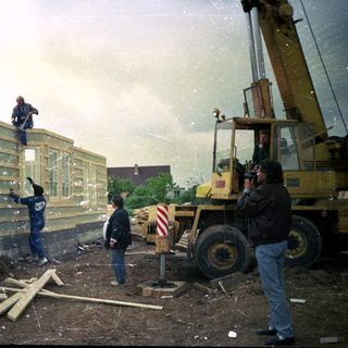 Construction site with workers assembling modular building units.