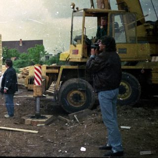 Construction site with workers assembling modular building units.
