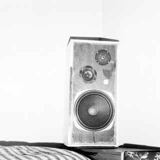 Vintage wooden speaker with two tweeters and woofer.