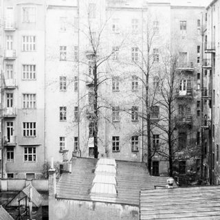 Urban courtyard with multi-story residential buildings.