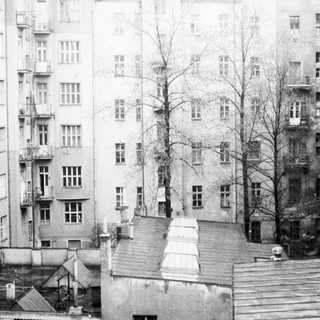 Urban courtyard with multi-story residential buildings.