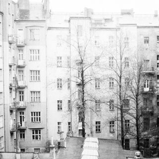 Urban courtyard with multi-story residential buildings.