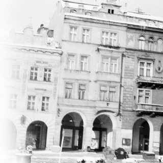 Historic European building with arched entrances and balconies.
