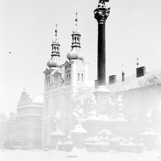 Baroque church with domes in snowy winter scene.