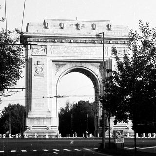 Grand arch monument with classical architectural details.